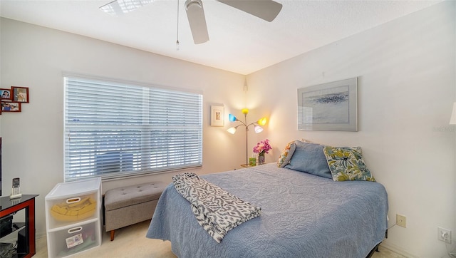 bedroom featuring light carpet and ceiling fan