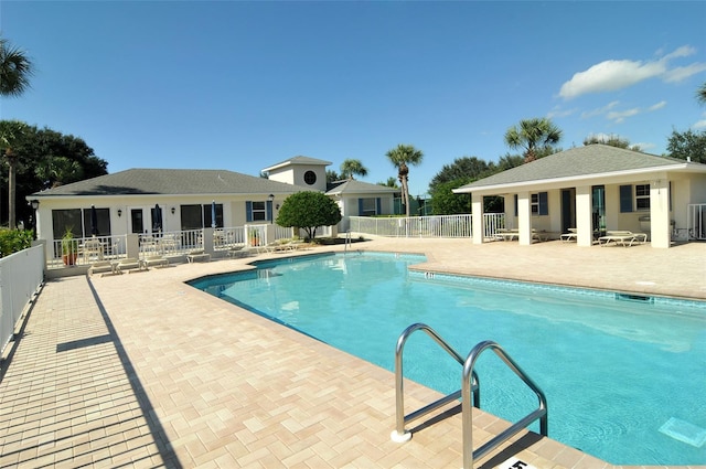 view of swimming pool featuring central AC unit and a patio