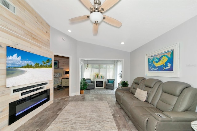 living room featuring ceiling fan, hardwood / wood-style flooring, and lofted ceiling