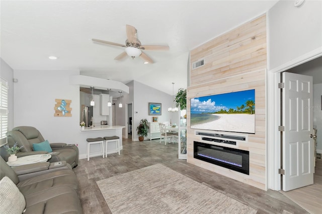 living room featuring ceiling fan, lofted ceiling, and hardwood / wood-style floors