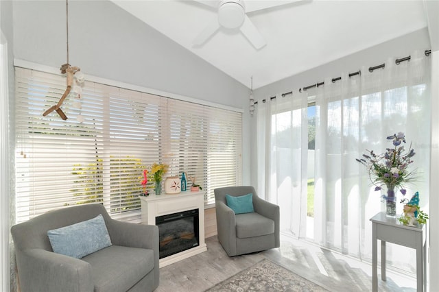 sitting room featuring wood-type flooring, lofted ceiling, and ceiling fan