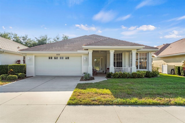 view of front of house featuring a garage and a front lawn