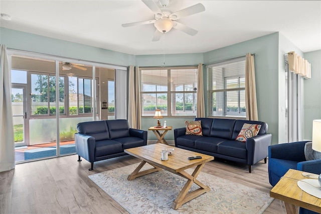 living room with light hardwood / wood-style floors and ceiling fan