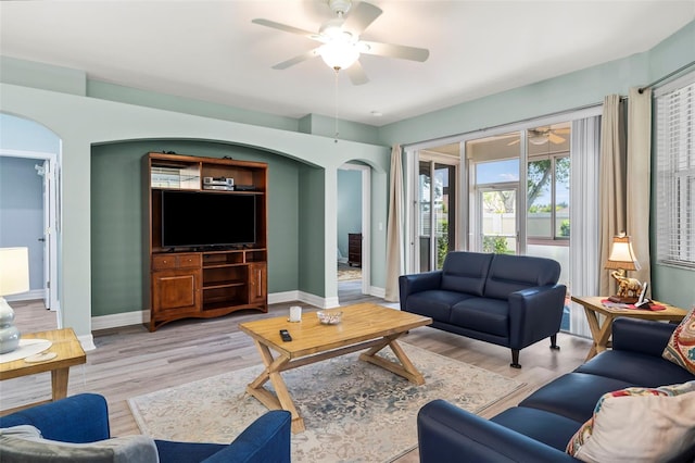 living room with light hardwood / wood-style floors and ceiling fan