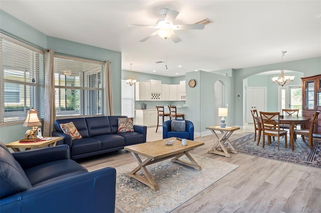 living room featuring light wood-type flooring and ceiling fan