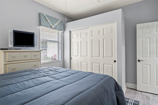 bedroom featuring a closet and light wood-type flooring