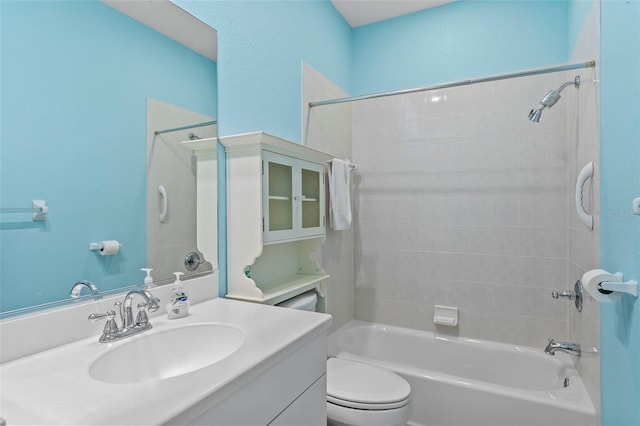 full bathroom with tiled shower / bath combo, vanity, and toilet