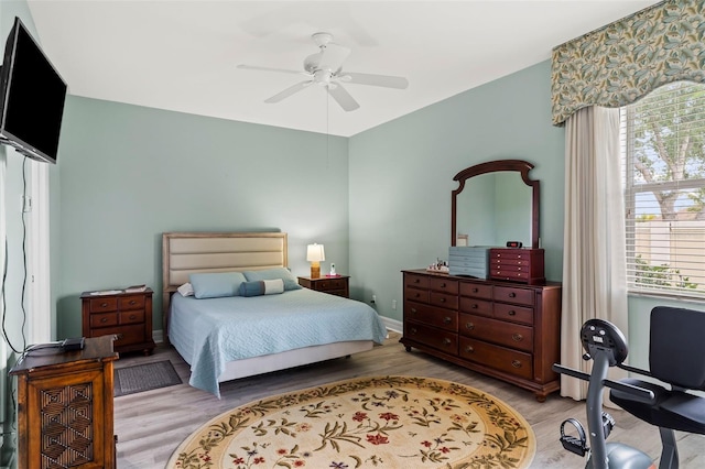 bedroom with ceiling fan and light wood-type flooring