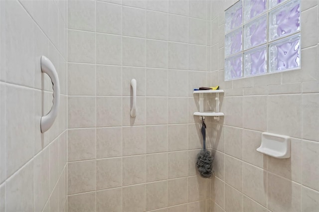 bathroom with a tile shower