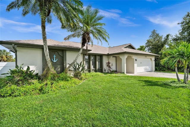 ranch-style home with a garage and a front lawn