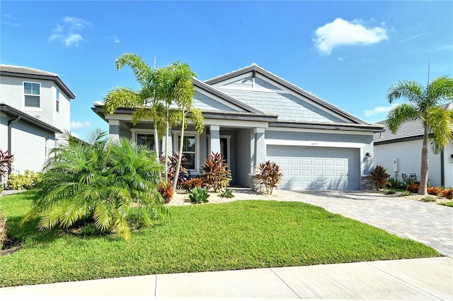 view of front of house with a garage and a front lawn