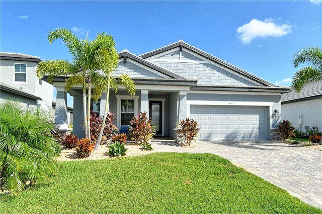 view of front of house featuring a front yard and a garage