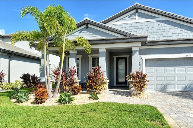 view of front of home with a garage and a front lawn