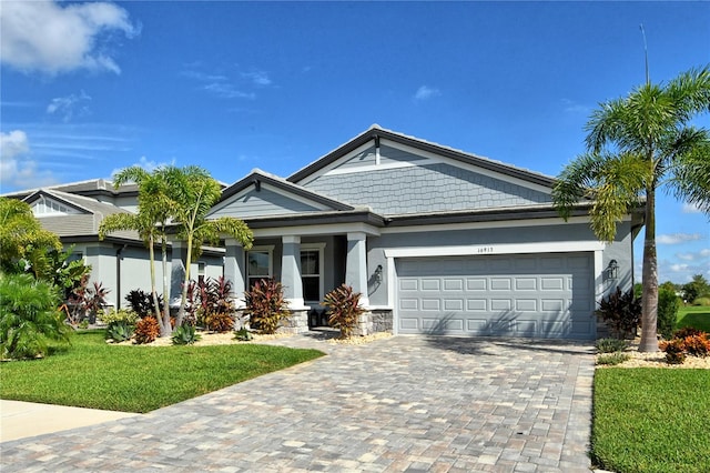 view of front facade with a front yard and a garage