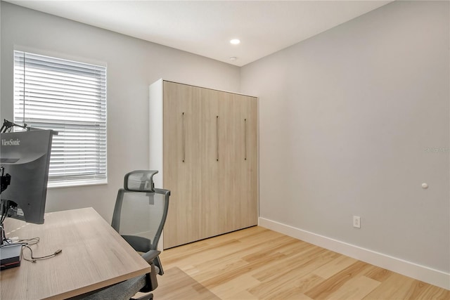 home office with light hardwood / wood-style floors