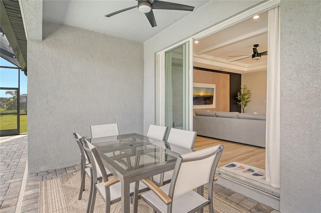 sunroom / solarium featuring ceiling fan