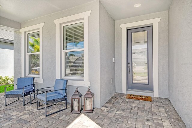 view of exterior entry with covered porch