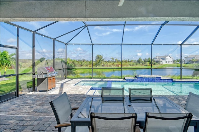 view of swimming pool with glass enclosure, grilling area, a water view, and a patio area