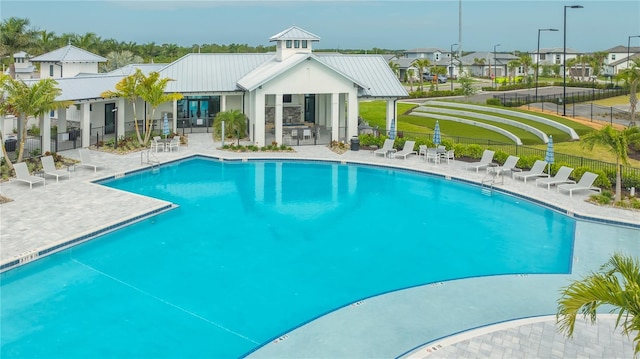 view of pool with a lawn and a patio area