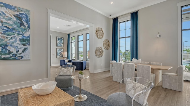 sitting room featuring light hardwood / wood-style flooring and ornamental molding