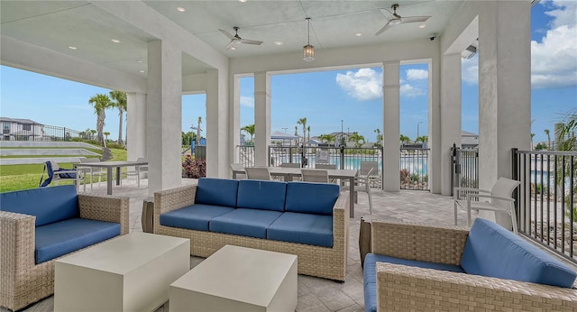 view of patio / terrace featuring a water view, outdoor lounge area, and ceiling fan