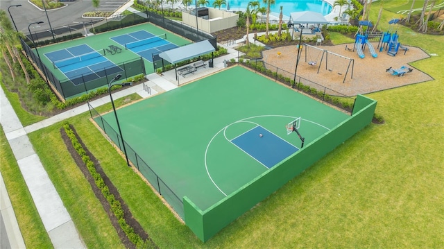 view of basketball court with a playground, tennis court, and a yard