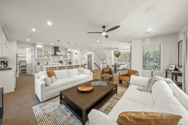 living room with hardwood / wood-style flooring and ceiling fan