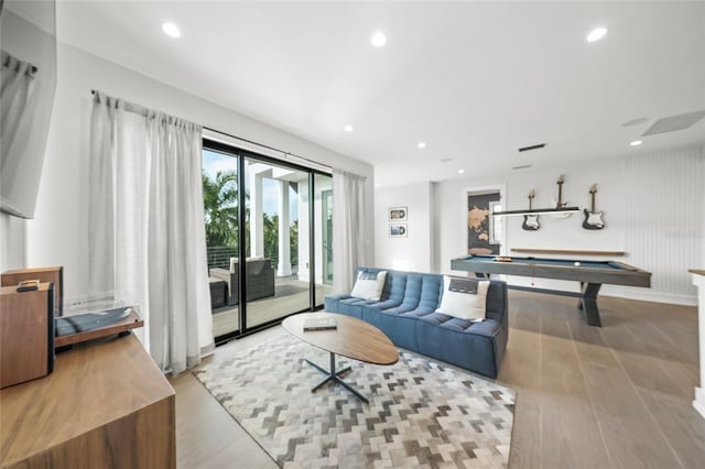 living room featuring light hardwood / wood-style floors and billiards