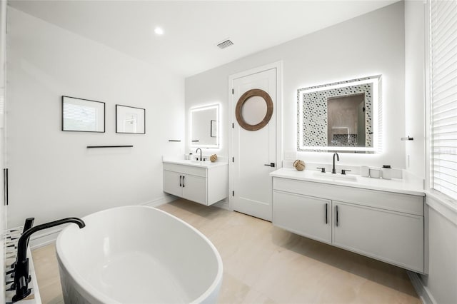 bathroom with vanity, tile patterned floors, and a bathtub