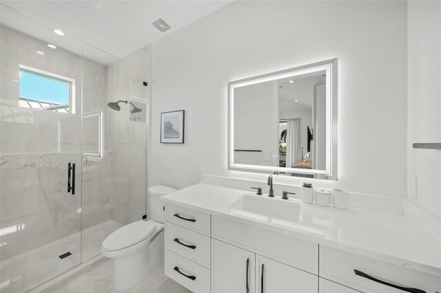 bathroom with vanity, a shower with shower door, and toilet