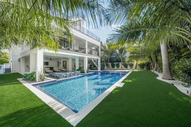 view of swimming pool with a lawn, a patio area, and an outdoor hangout area