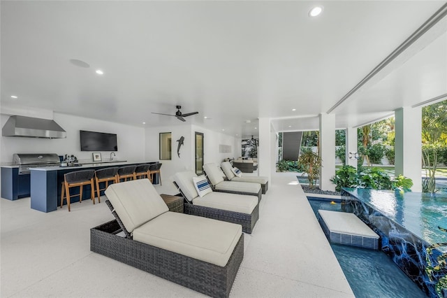 view of patio / terrace with exterior bar, an outdoor kitchen, and a grill