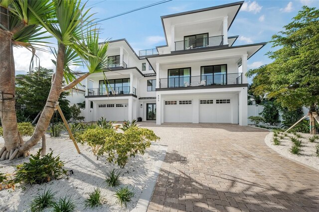 contemporary home featuring a balcony and a garage