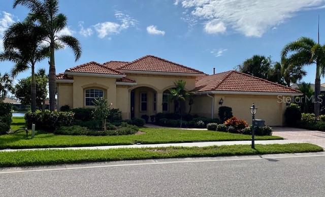 mediterranean / spanish-style home featuring a front lawn