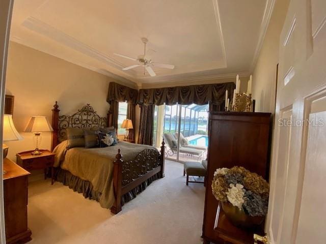 bedroom with a tray ceiling, ceiling fan, carpet flooring, and crown molding