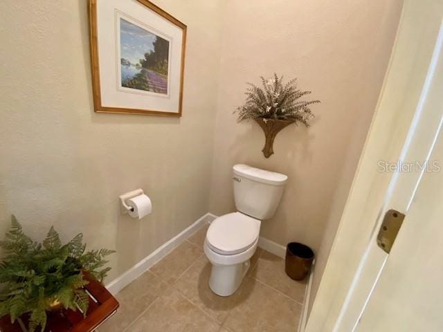 bathroom featuring tile patterned flooring and toilet