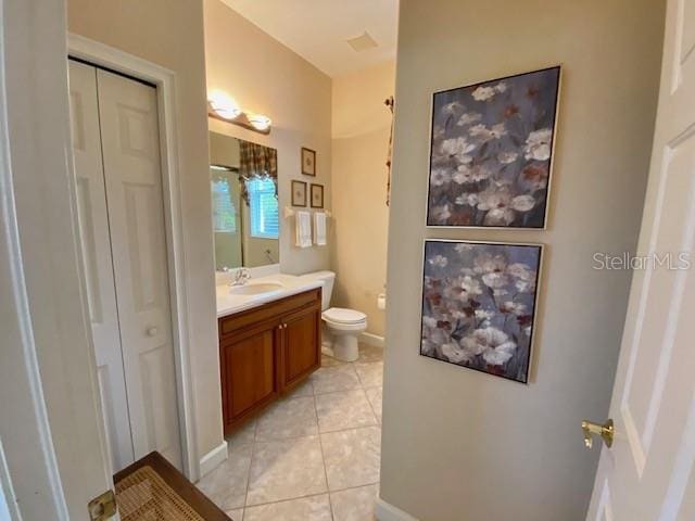 bathroom with tile patterned flooring, vanity, and toilet