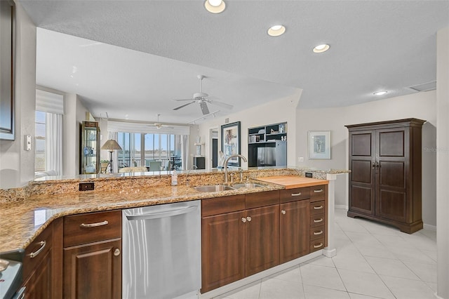 kitchen with ceiling fan, a textured ceiling, sink, and stainless steel dishwasher