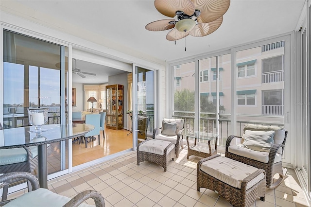 sunroom featuring ceiling fan