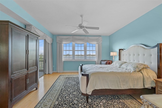 bedroom featuring access to outside, light hardwood / wood-style floors, and ceiling fan