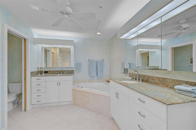 bathroom with a relaxing tiled tub, tile patterned floors, ceiling fan, vanity, and toilet