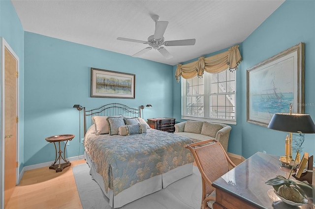 bedroom with ceiling fan and light hardwood / wood-style flooring