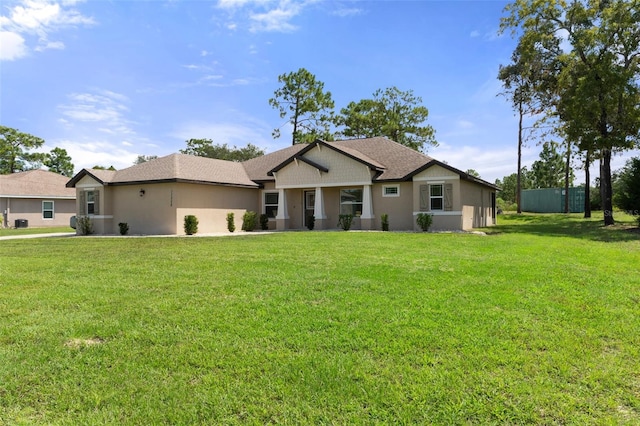 single story home featuring a front lawn