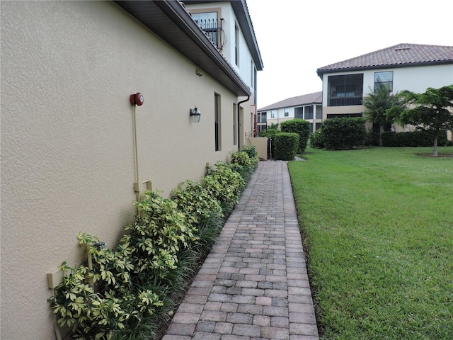 view of side of home featuring a yard