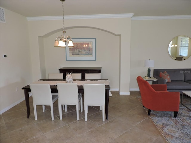 tiled dining space featuring a chandelier and crown molding