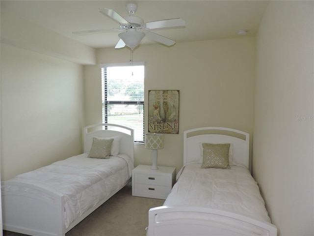 bedroom featuring ceiling fan and light colored carpet