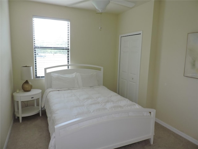 bedroom with a closet, ceiling fan, and carpet floors