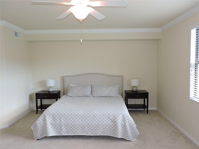 carpeted bedroom with ornamental molding and ceiling fan