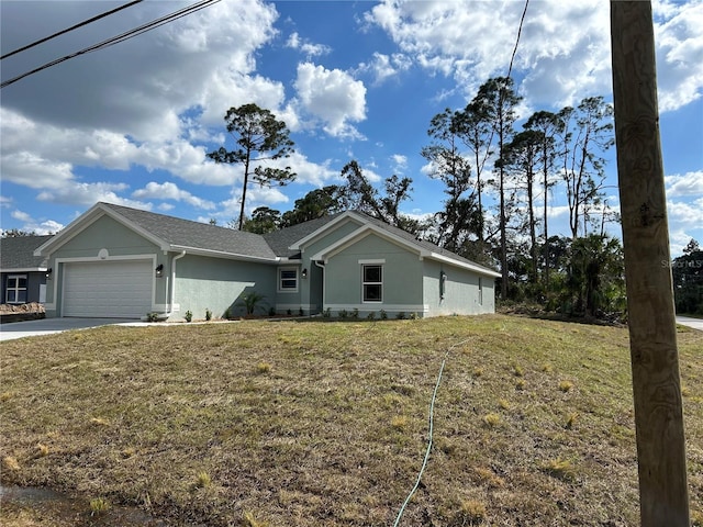 ranch-style house featuring a garage and a front lawn