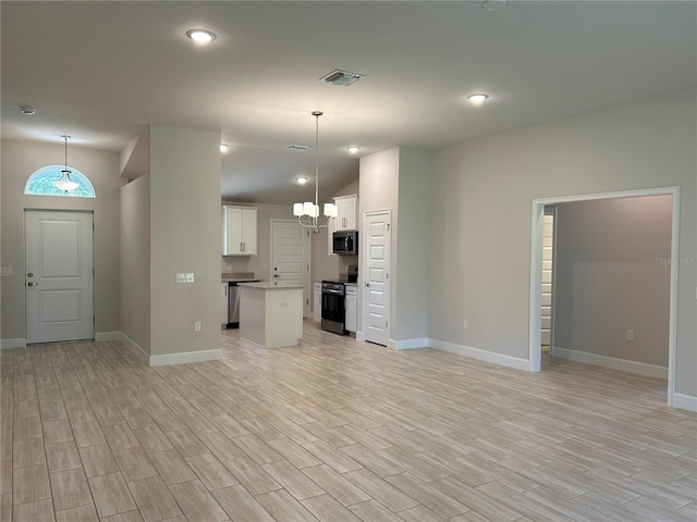5661 Gaffney Rd, North Port, FL 34286 - unfurnished living room featuring light wood-style flooring, lofted ceiling, a chandelier, and recessed lighting